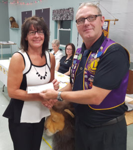 Ling Lion Barry LeBlanc presents a Lions Club donation of $1,500 to the Strait-Richmond Health Care Foundation board member Pat Burns.