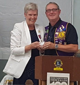 King Lion Barry LeBlanc presents District Governor Claire Brunnell with a Lions Dragon Fly Pin.