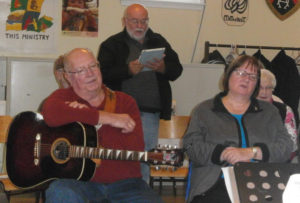 Photo by Cathy Cooke Tom Oram (standing) of Hudson, Massachusetts was one of the music lovers who raised their voices for the “Causeway Song Session,” a Celtic Colours community event held at St. David’s United Church in Port Hastings on October 14. Port Hawkesbury’s Sandy MacLean (holding guitar) and West Bay’s Barbara MacKay (front, right) also shared a couple of their favourite songs.  