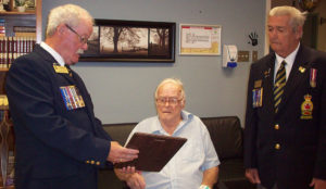 Legion members Frank Rideout and Jerry Doiron presented a plaque to Mort McGrath to commemorate his 60 years of membership.