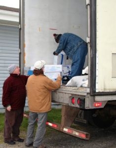 Lion Father Dan MacDonald and Lion Barry Lumsden help unload fish for Canso Lions Club.