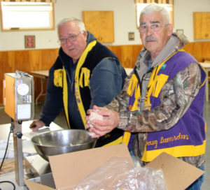Canso Lions Clayton Haines and Bill Roberts weigh an order of cod tongues. 