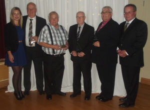 Long-running business owners joining the Strait Area Chamber of Commerce Club 50 during the chamber’s Fall Awards Dinner at the Port Hawkesbury Civic Centre included (from the left): Zutphen Contractors, represented by Danielle and Ted VanZutphen; Louis’ Cosy Corner, represented by Louis Boudreau; Causeway Autobody, represented by Jerome Tracey; and Dennis Haverstock Funeral Home, represented by John Langley. Chamber president David Hart (far right) presided over the Club 50 presentations. 