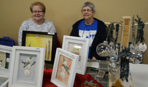 Three-dimensional art was the offering made by Violet Bonin (left) and Muriel Samson at the D’Escousse Civic Centre. The ladies were all smiles on Saturday. 