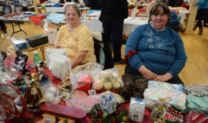 Gloria Hayes (left) and Catherine Tatten had loads of items on the table to help brighten the holidays.