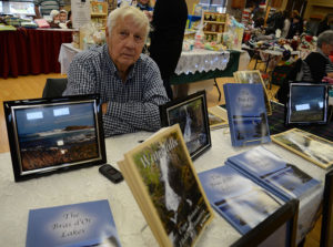 Offering books and framed photos at the annual holiday bonanza was Wally Ellison, who can also be read weekly in The Reporter.
