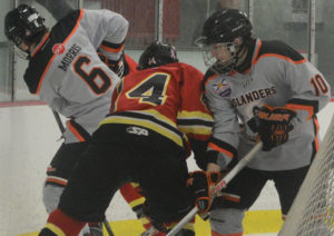 Jack Morris (left) and Fearghus MacDonald battle for the puck behind Islander goalie Ewan MacDonald.